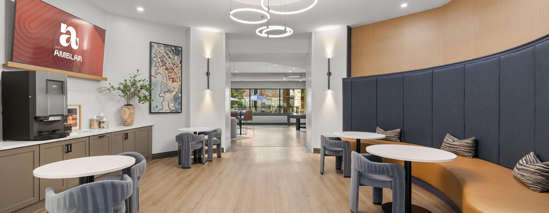 bench along wall with tables in clubhouse